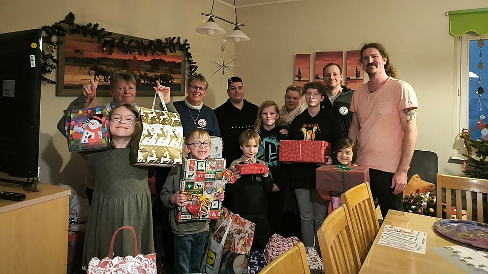 Nordkurier 21.12.2026 Bild zeigt die Gruppe von Kindern aus dem Kinder- und Jugendwohnhaus "Heimathafen" mit ihren Geschenken. im Hintergrund sind einige Mitglieder des GHV94 e.V. sowie Mitarbeiterinnen aus dem Jugendwohnhaus.