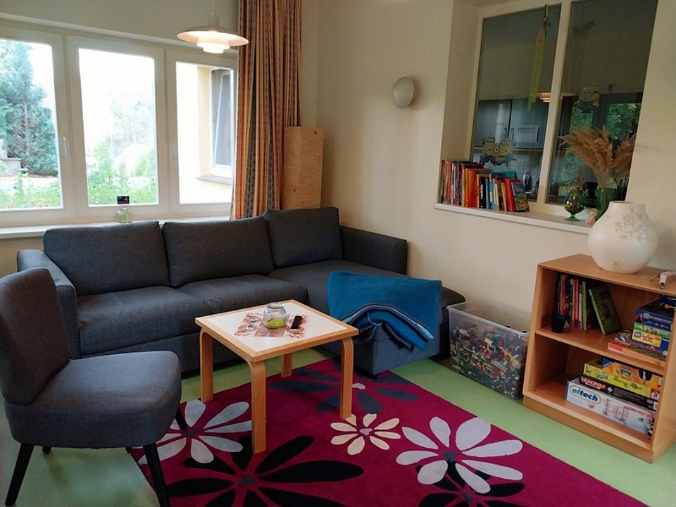 Bild zeigt einen Blick in einen Wohnraum (gleicher wie auf vorhergehenden Bild)  mit Sofa, Sessel usw. aus einer zweiten Perspektive