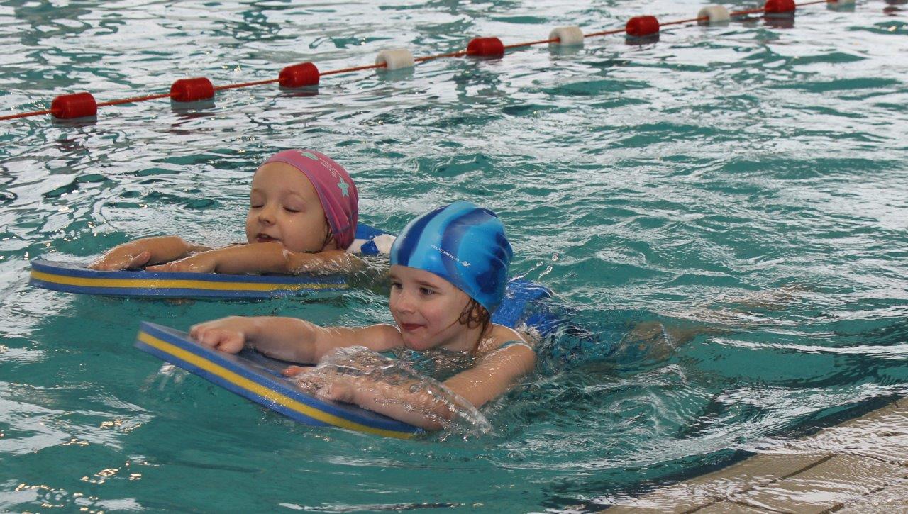 Bild zeigt zwei kleine Kinder beim Schwimmunterricht